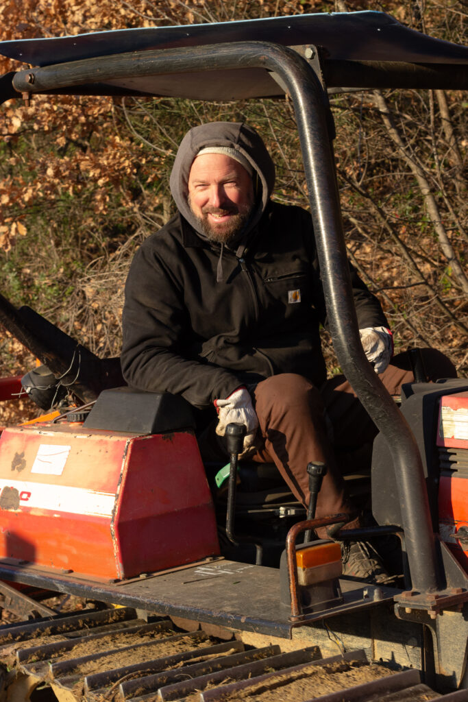 La Torre alle Tolfe Sascha on a tractor in vineyard